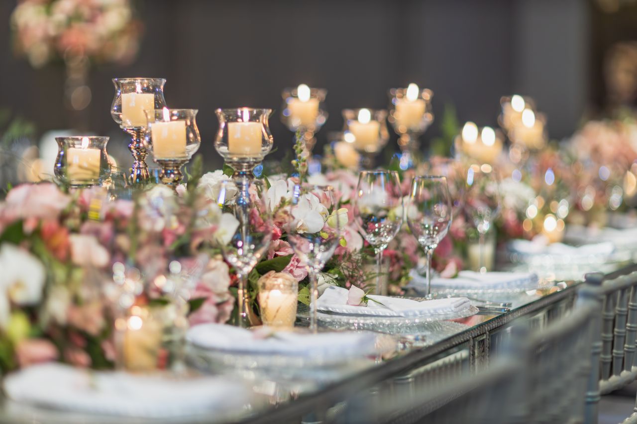 journey A beautifully decorated wedding table featuring candles and floral arrangements, perfect for elegant receptions.